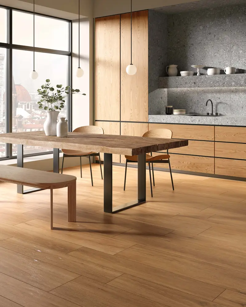 Kitchen with a wooden table and natural wood-effect porcelain floor tiles
